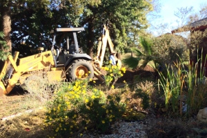 Digging trenches and hole for septic system.