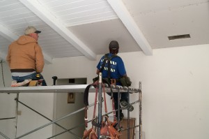 Sean and Adam install drywall for ceiling.