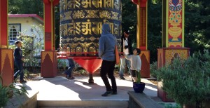 Turning the giant prayer wheel at the Land of the Medicine Buddha.