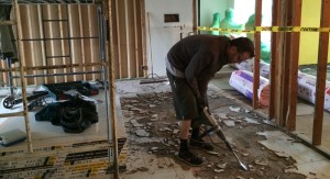Removing the old tile flooring is messy, but necessary.