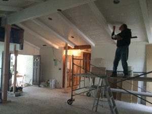 Steve works on applying mud to the ceiling drywall.
