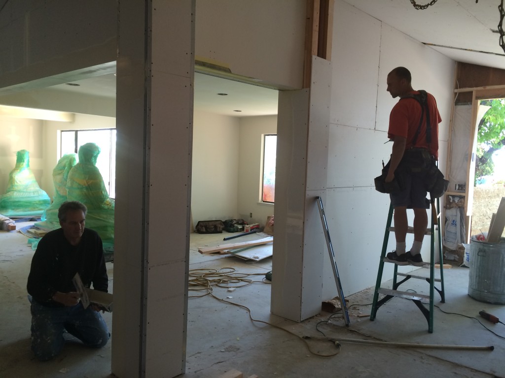 Charlie works on entry hall while Steve finishes the drywall.