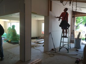 Charley installs the drywall in the new entryway. A painting of the "Wheel of Life" will go on this wall.