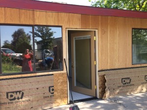 The bricks have been removed and wall and door replaced leading to Community Room.