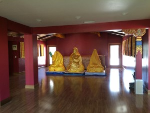 Three Buddhas waiting to go on altar in Main Buddha Hall.