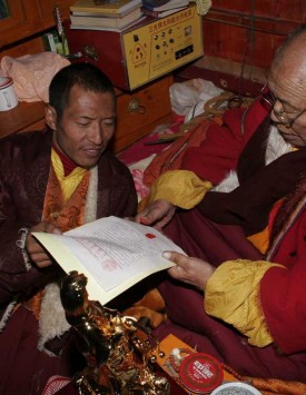 Lama Achuk applying his thumbprint to the letter to H.H. Dorje Chang Buddha III