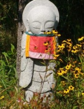Jizo with red bib from the Gafton Peace Pagoda.