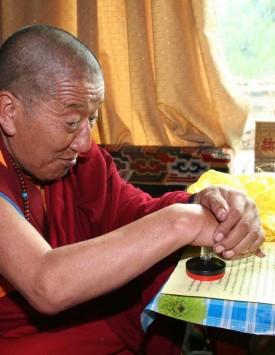 Dharma King Jigme Dorje stamps his seal onto his congratulatory letter to H.H. Dorje Chang Buddha III that he had already signed.