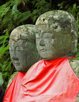 Jizo Statues in Japan wearing red bibs for deceased children and fetuses Some statues would have many layers of bibs.
