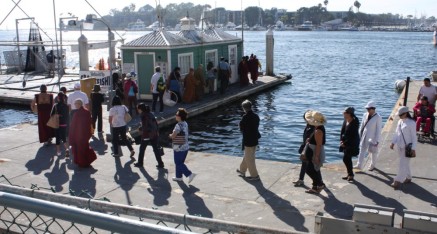 Friends, family, and clergy proceed to dock for fish release and to board boat to go out to sea.