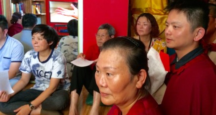 Visitors from China and Taiwan watch video about the Fourth Vajra Throne  (a Vajrasana) and the Holy Vajra Poles