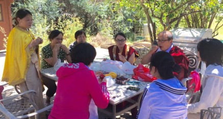 Visitors from China enjoy a picnic lunch at the temple
