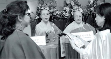 Following the proper etiquette to show respect to those of holy virtue, representatives attending the seminar check the authenticity of the certificates of those of holy virtue.