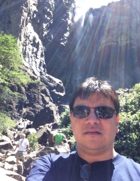 Lawrence Po from Canada stands in front of Bridal Mist Falls in Yosemite National Park