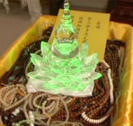 Green light manifests in stupa holding the Holy Vajra Pill as blessings are sought for various malas.