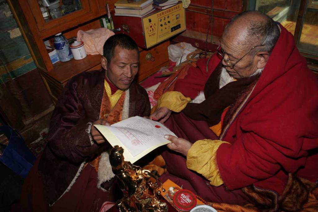 Lama Achuk applying his thumbprint to the letter to H.H. Dorje Chang Buddha III