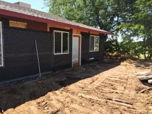 The old driveway and sidewalks are gone and the front is almost ready for stucco.