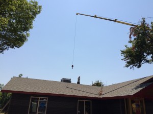 The crew on the roof guided the crane into position.