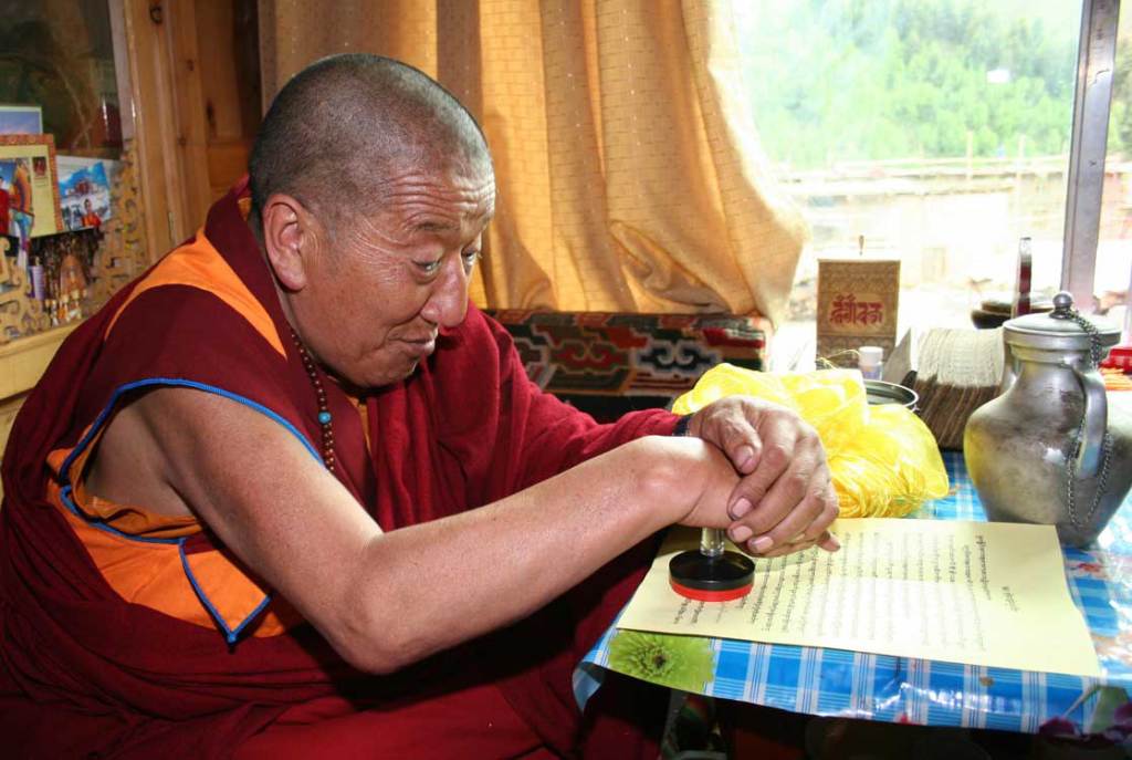 Dharma King Jigme Dorje stamps his seal onto his congratulatory letter to H.H. Dorje Chang Buddha III that he had already signed.